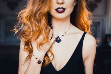 Woman with copper waves and dark lipstick