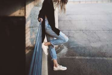 Casual denim and sneakers on city steps