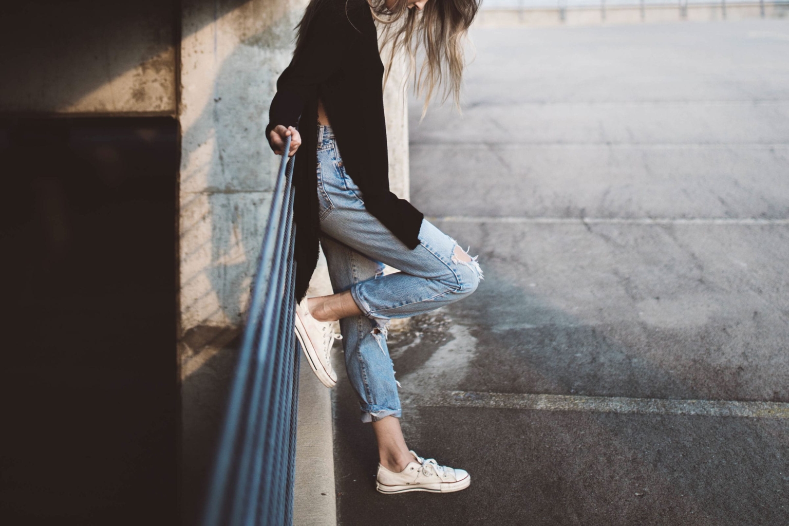 Casual denim and sneakers on city steps